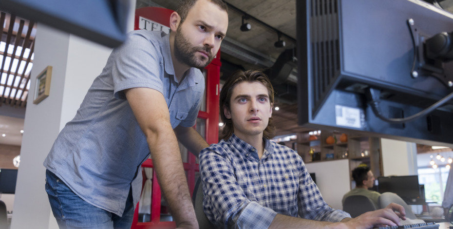 2 men looking at computer screen